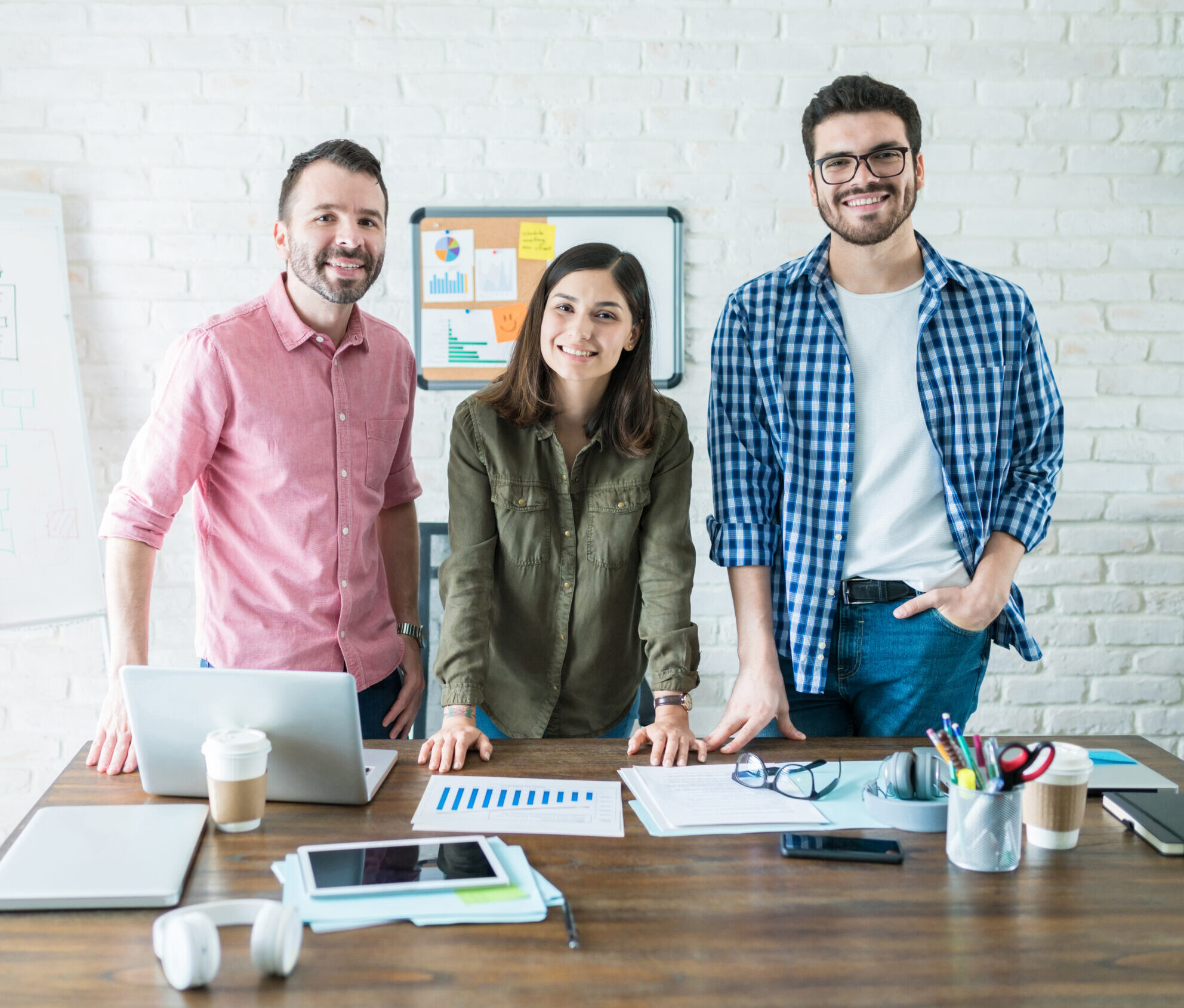 Smiling Business Team In Conference Room At Office Portrait of confident professionals standing at conference table in meeting room at office